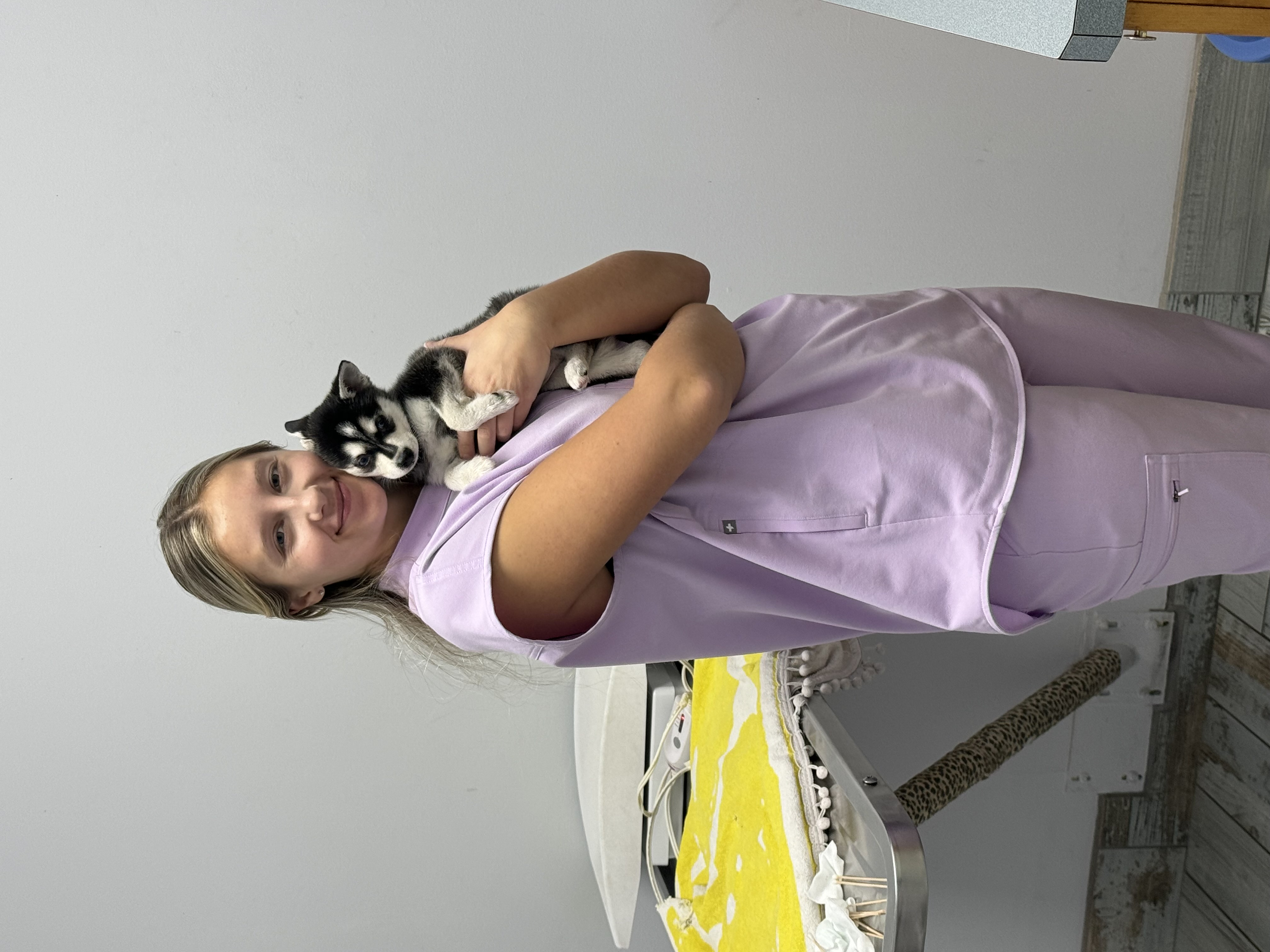Veterinary technician holding a husky puppy at Ramtown Animal Hospital